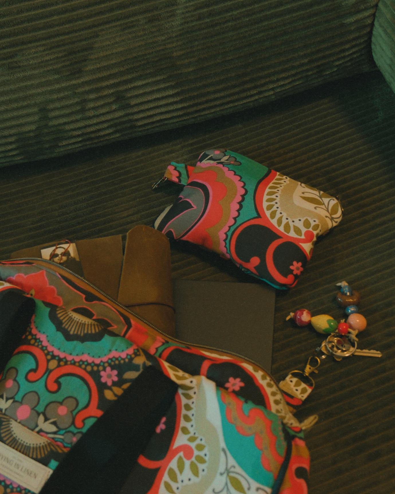 Colorful patterned bag and pouch on a textured surface