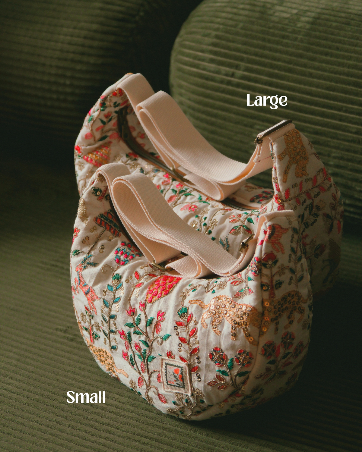 A quilted floral shoulder bag with beige straps, styled on a textured olive green couch. The image features text overlays indicating sizes 'Large' and 'Small'.